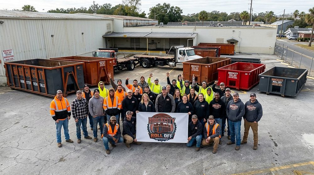 The BrickCity Roll Off team with branded roll-off containers and trucks
